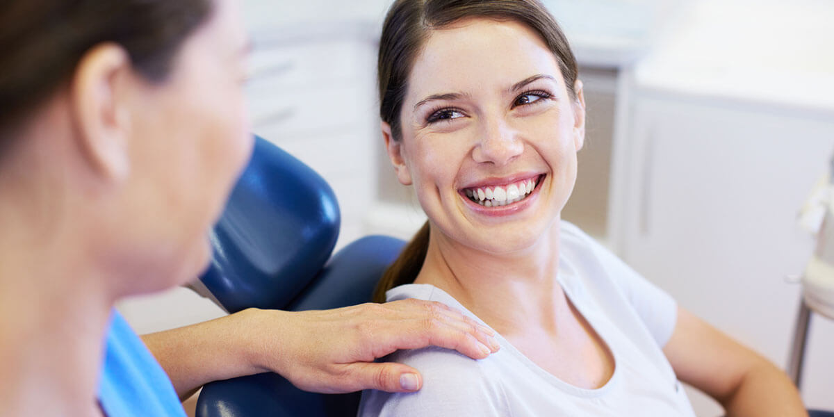 Woman in dental chair smiling