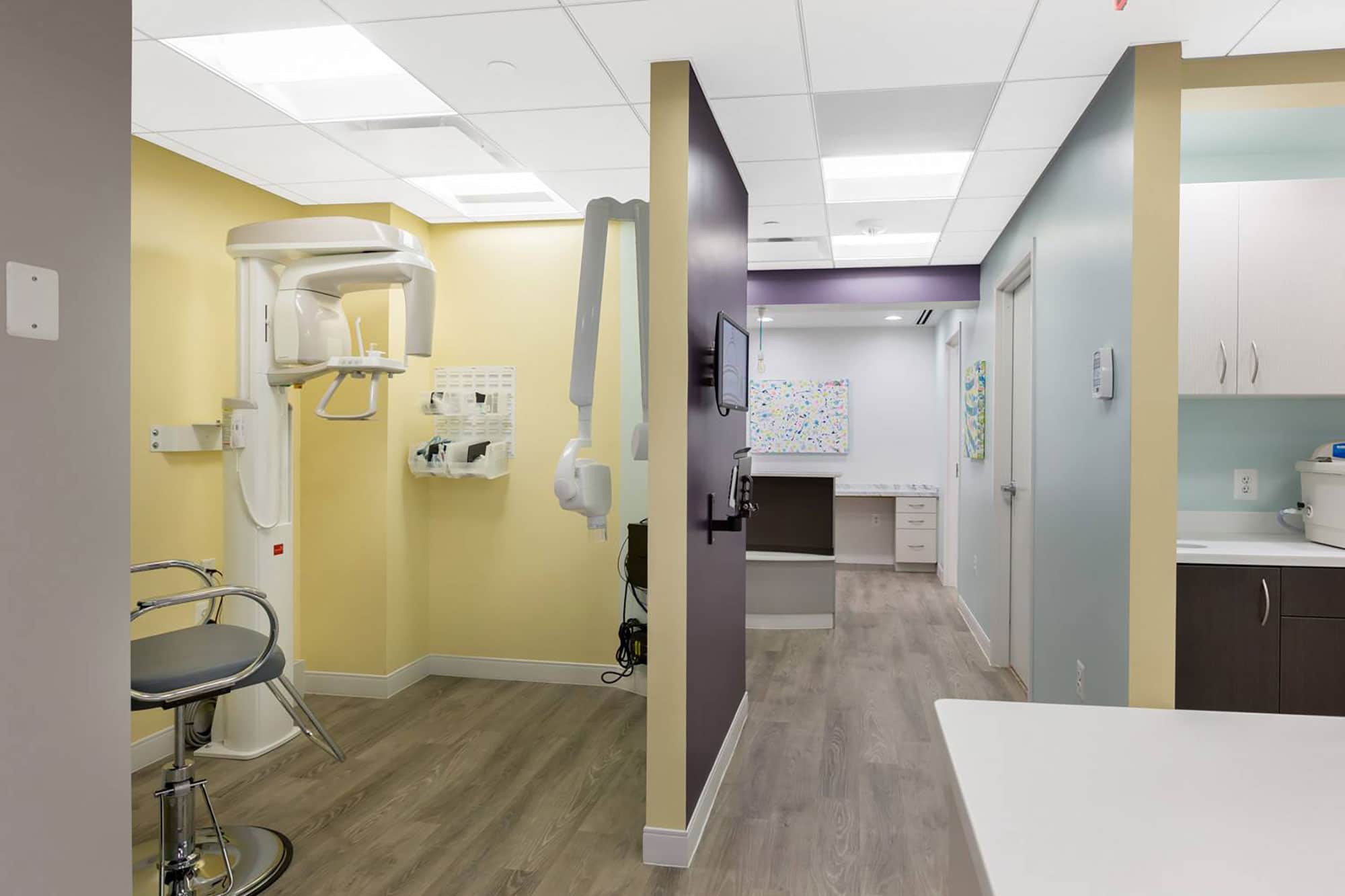x-ray area in dental office with wood floors and yellow walls