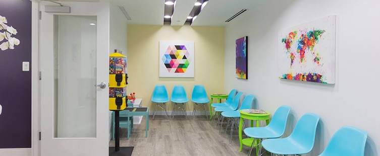 dental reception area with turquoise seats and kids play table